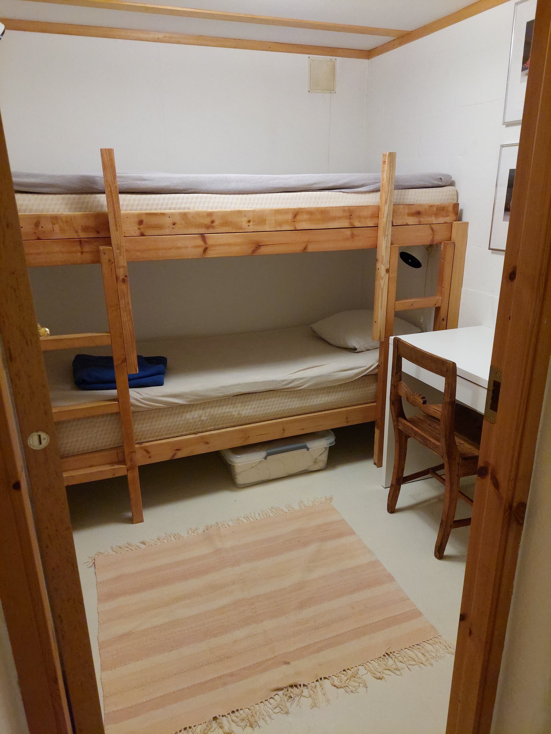 Bunk room with a wooden bunk bed frame
