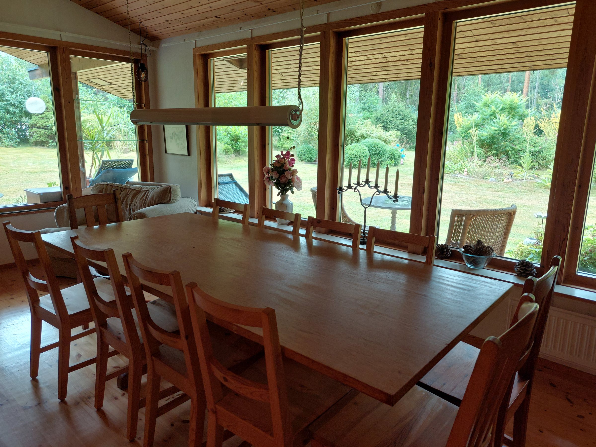 Dining room with a wall of windows looking onto the garden